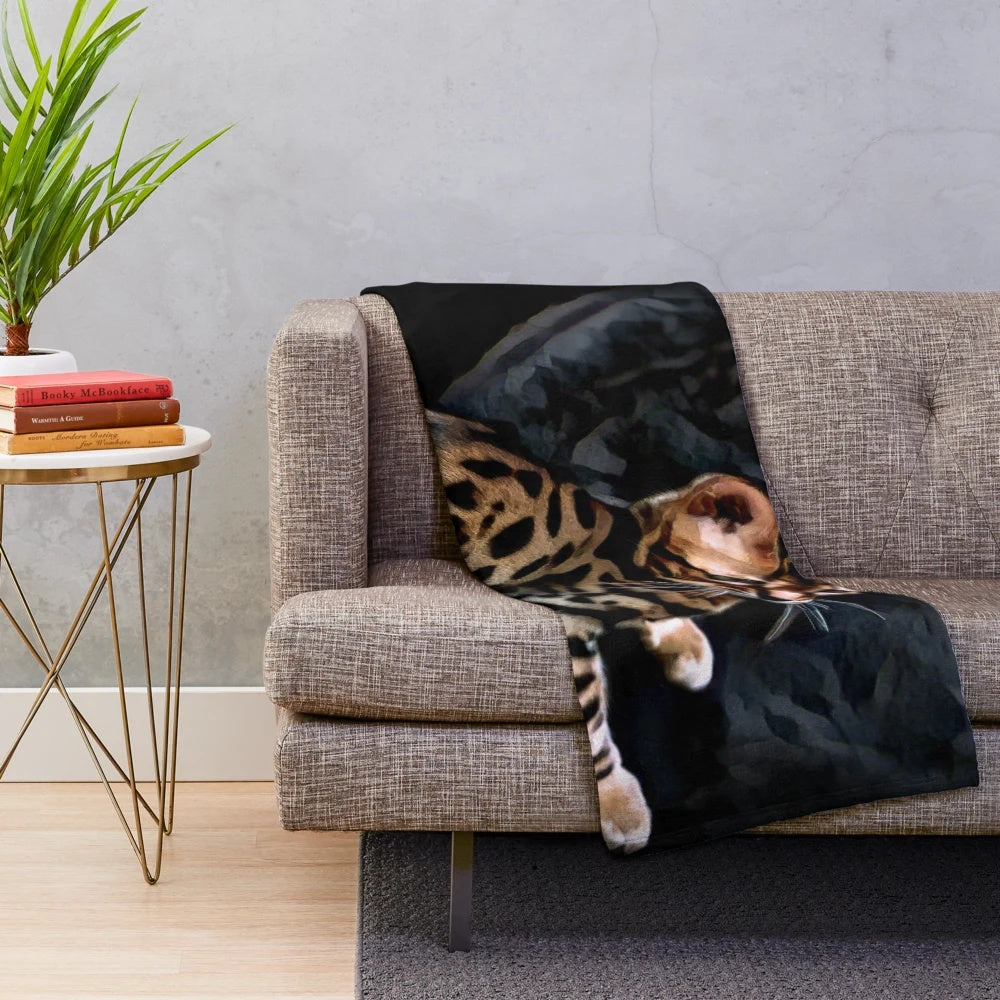 Gold Bengal kitten on a dark background plush blanket