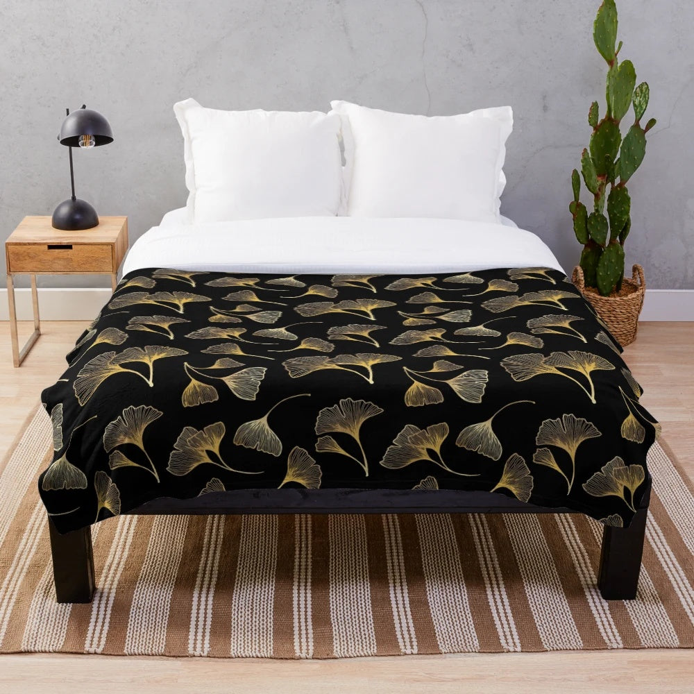 Closeup of a plush blanket with a golden leaf pattern