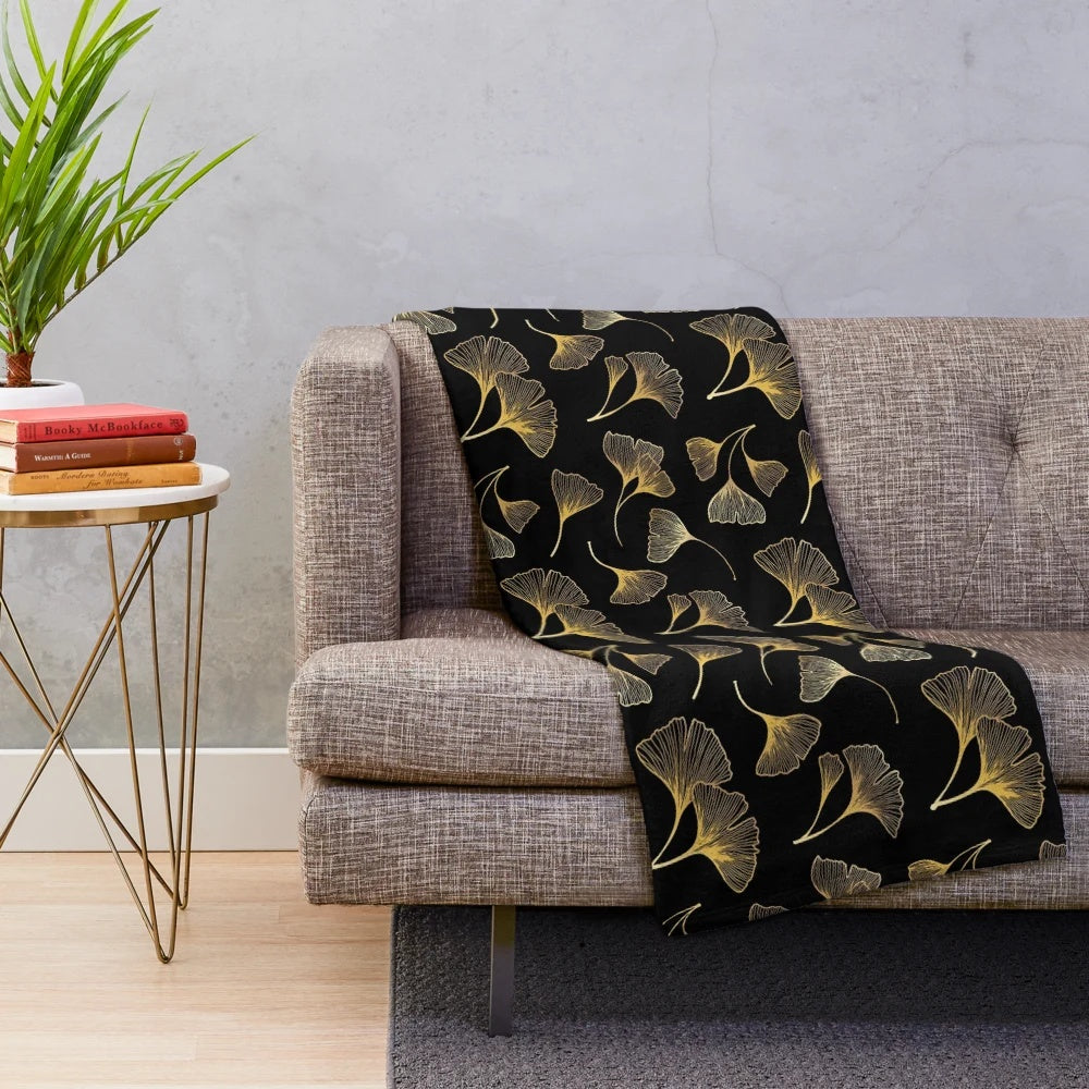 Closeup of a plush blanket with a golden leaf pattern