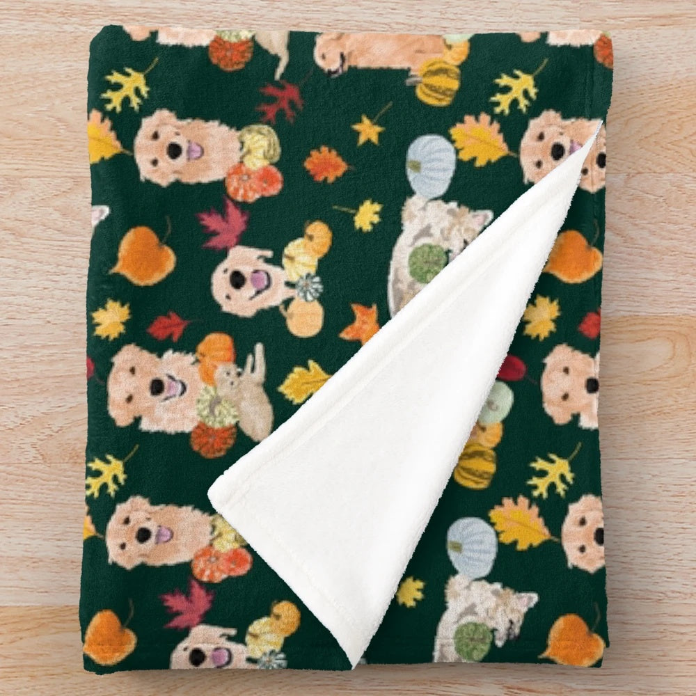 Golden Retriever curled up on a soft, plush fall-themed blanket