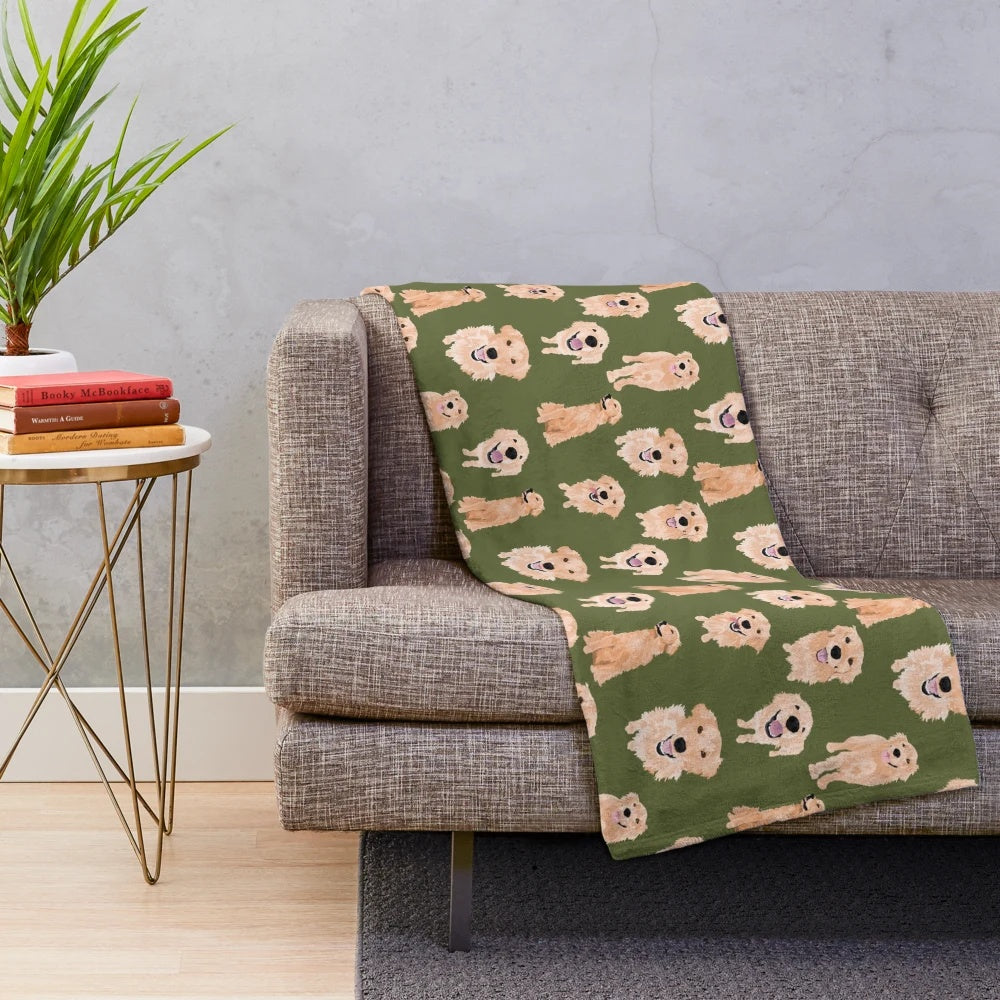 Golden retriever puppy lying on a soft, olive-colored plush blanket