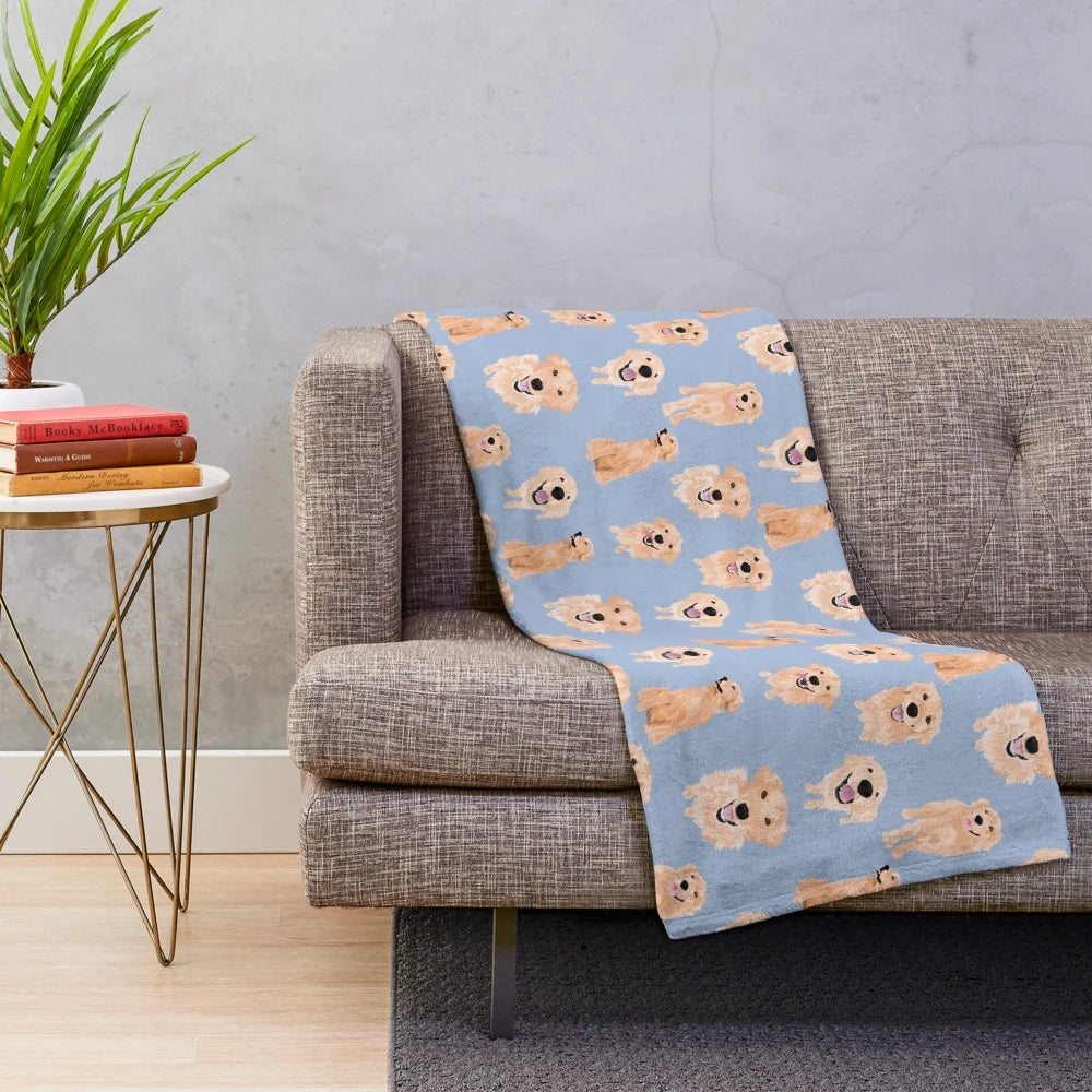 Golden retriever dog lying on a soft, blue plush blanket