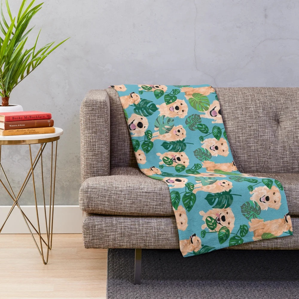 Golden Retriever curled up on a tropical-themed plush blanket