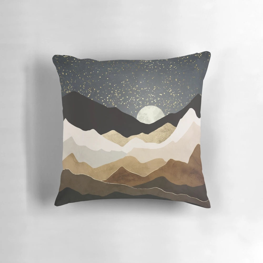 A luxurious throw pillow featuring a serene landscape with glowing golden stars against a night sky