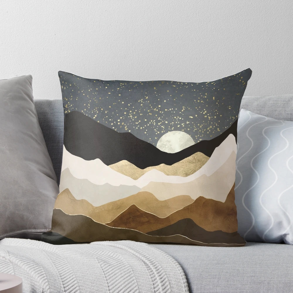 A luxurious throw pillow featuring a serene landscape with glowing golden stars against a night sky