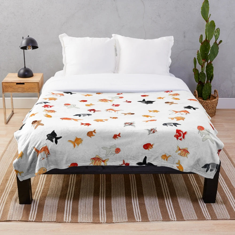 Plush goldfish themed blanket with a collage of different fancy goldfish breeds