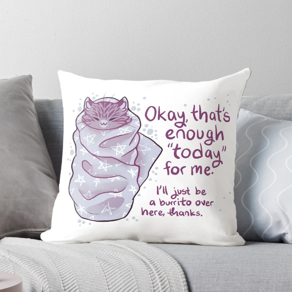 Soft, gray plush pillow in the shape of a cat burrito or "purrito" for comfort and self-care.