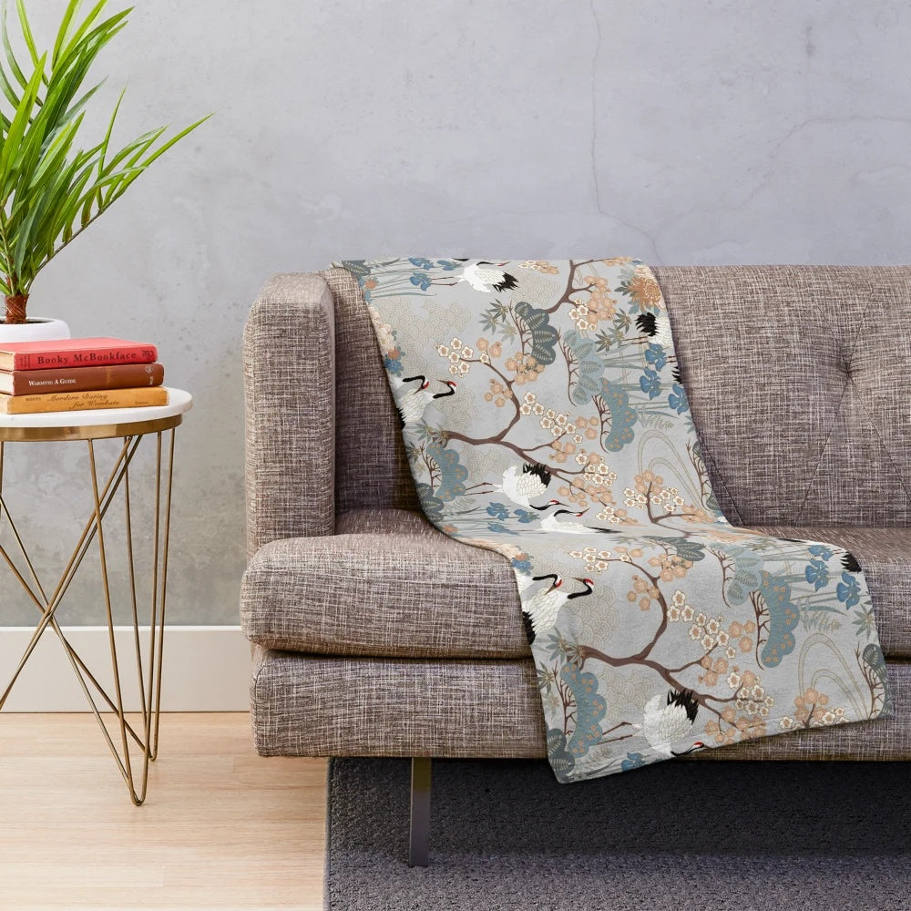 Gray plush blanket with Asian-inspired floral design and red-capped cranes