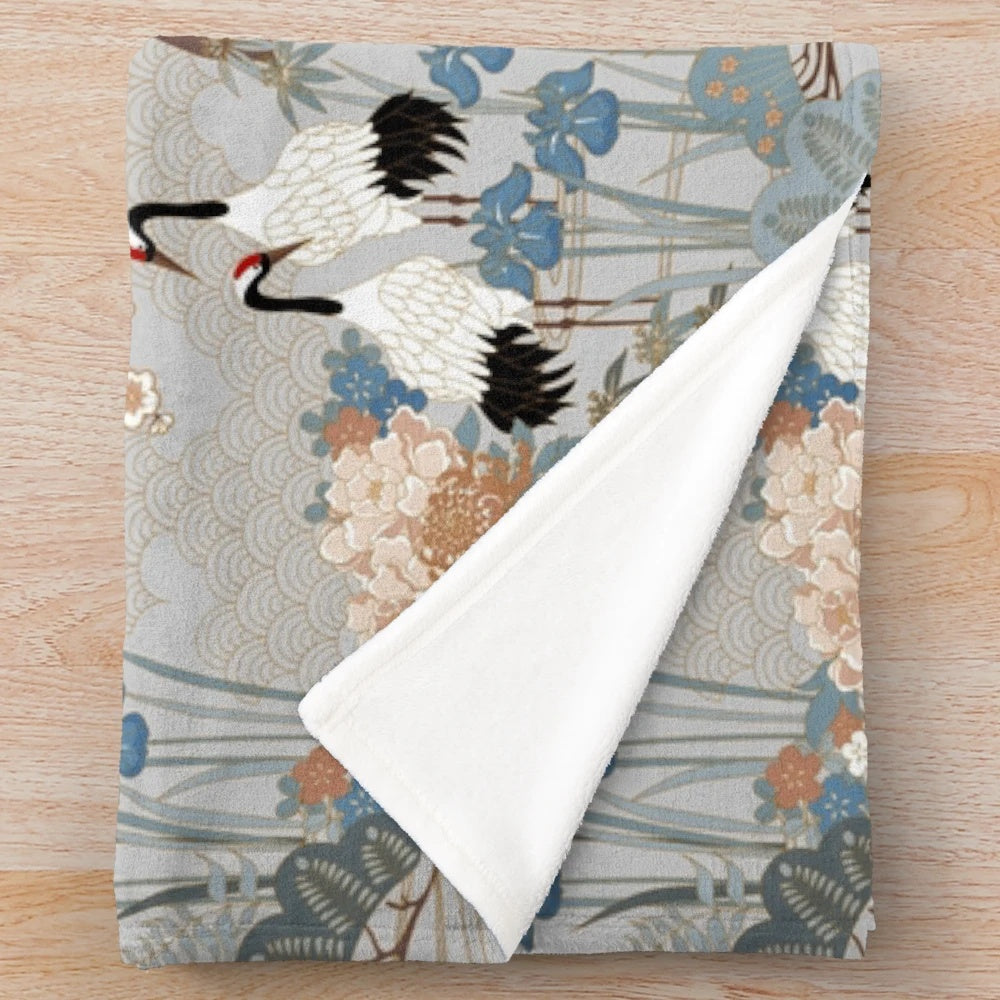 Gray plush blanket with Asian-inspired floral design and red-capped cranes