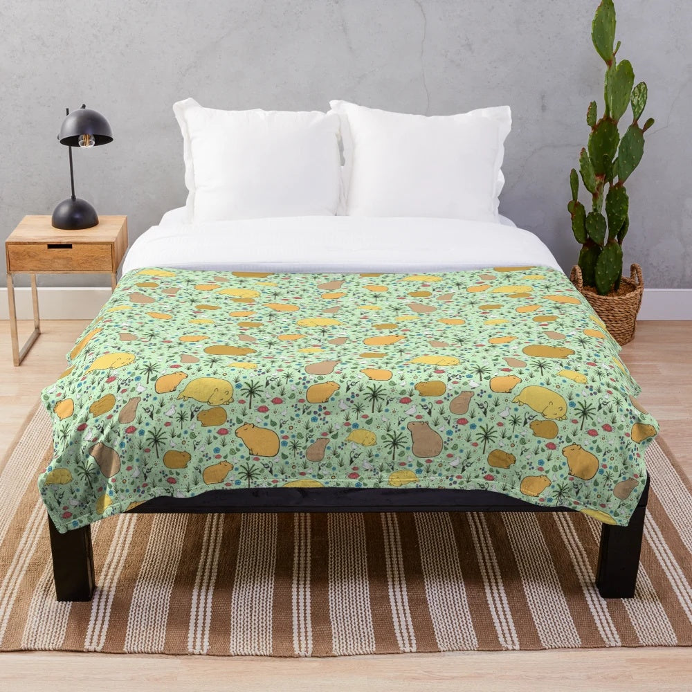 Soft and cuddly green plush blanket featuring adorable capybara design