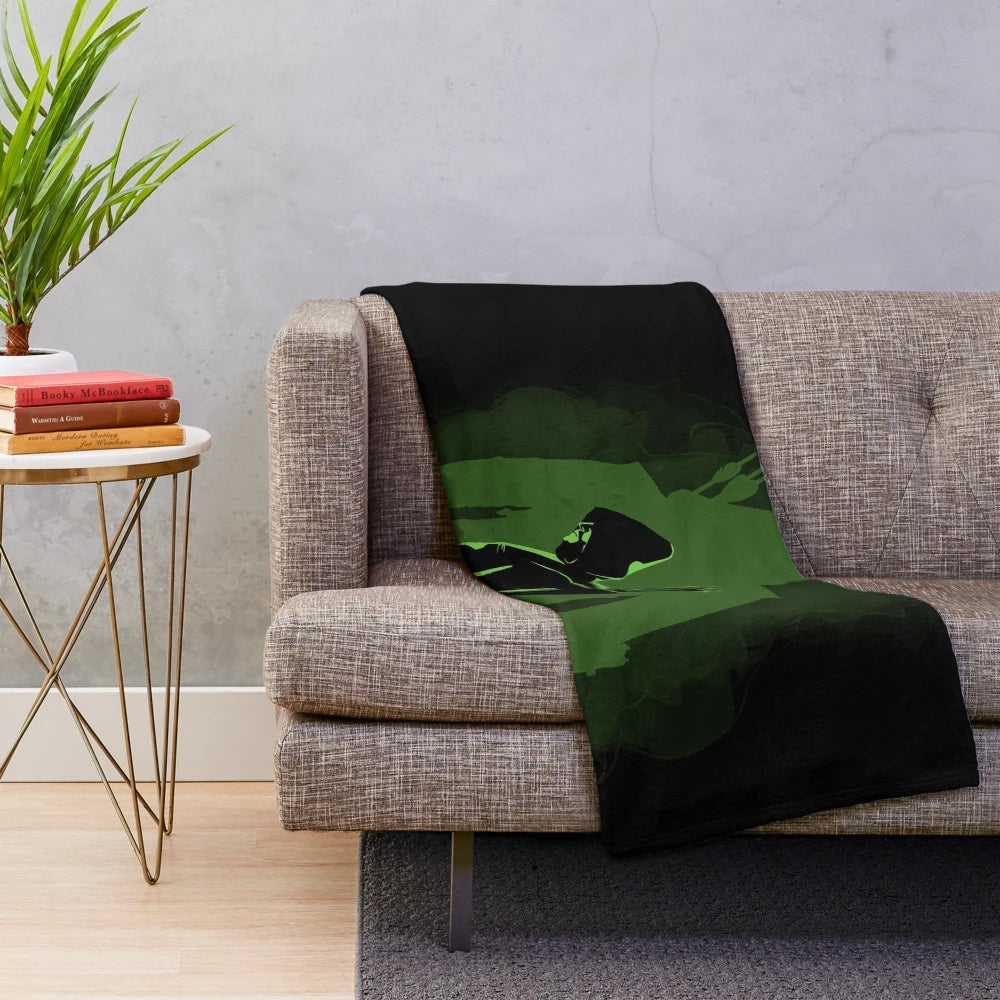 Green plush blanket with superhero-inspired design