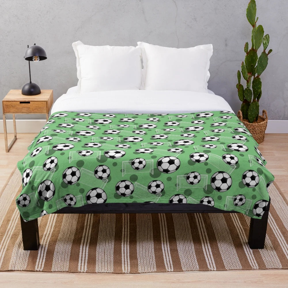 Green soccer pattern plush blanket with soccer ball and goal design