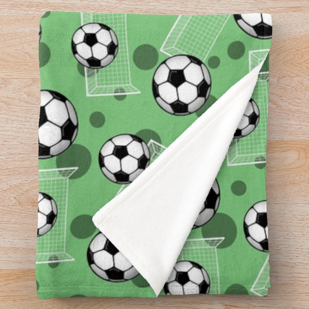 Green soccer pattern plush blanket with soccer ball and goal design