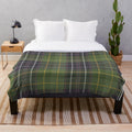 Green tartan plush blanket with nature and floral elements