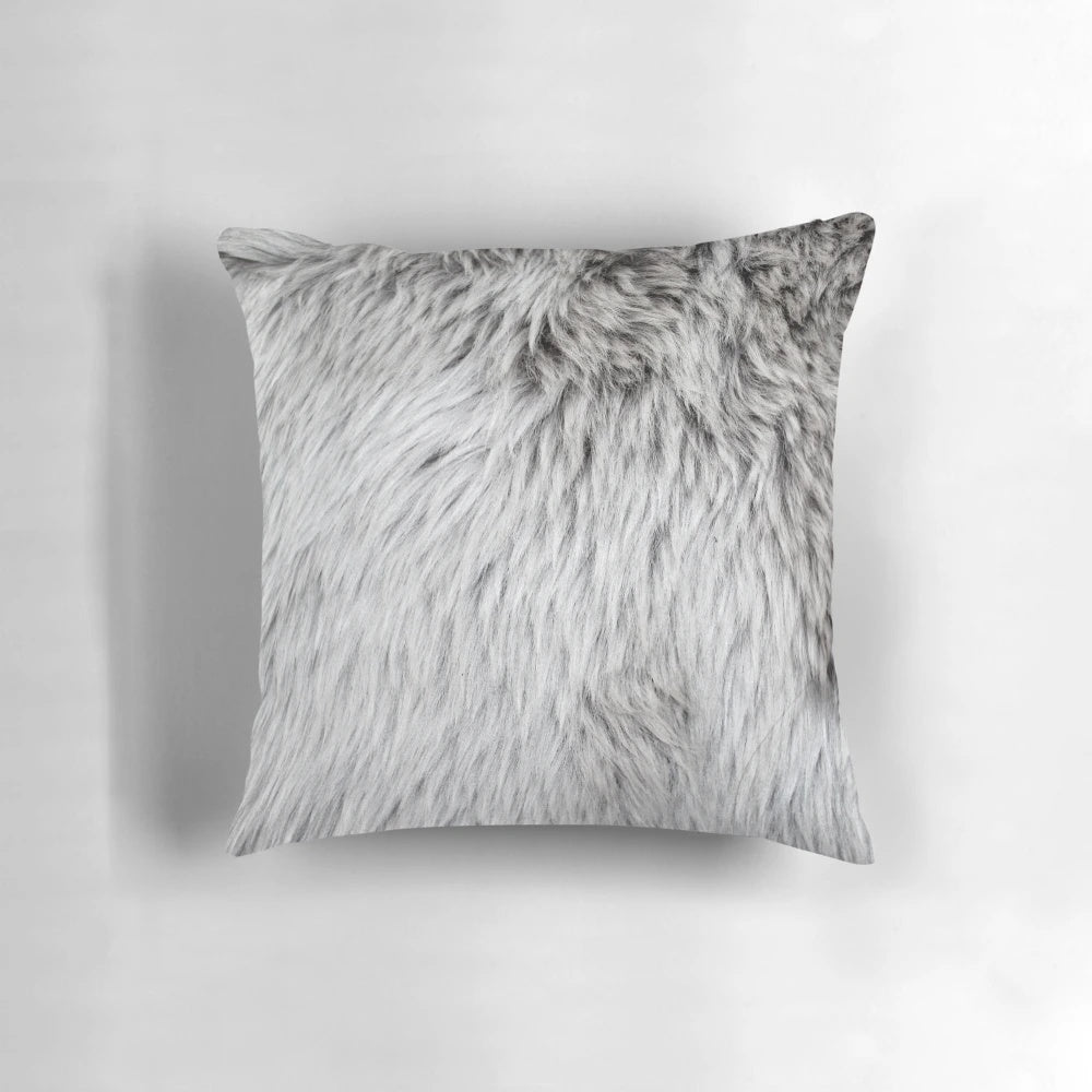Close-up of a soft, fluffy grey faux fur pillow