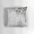 Close-up of a soft, fluffy grey faux fur pillow