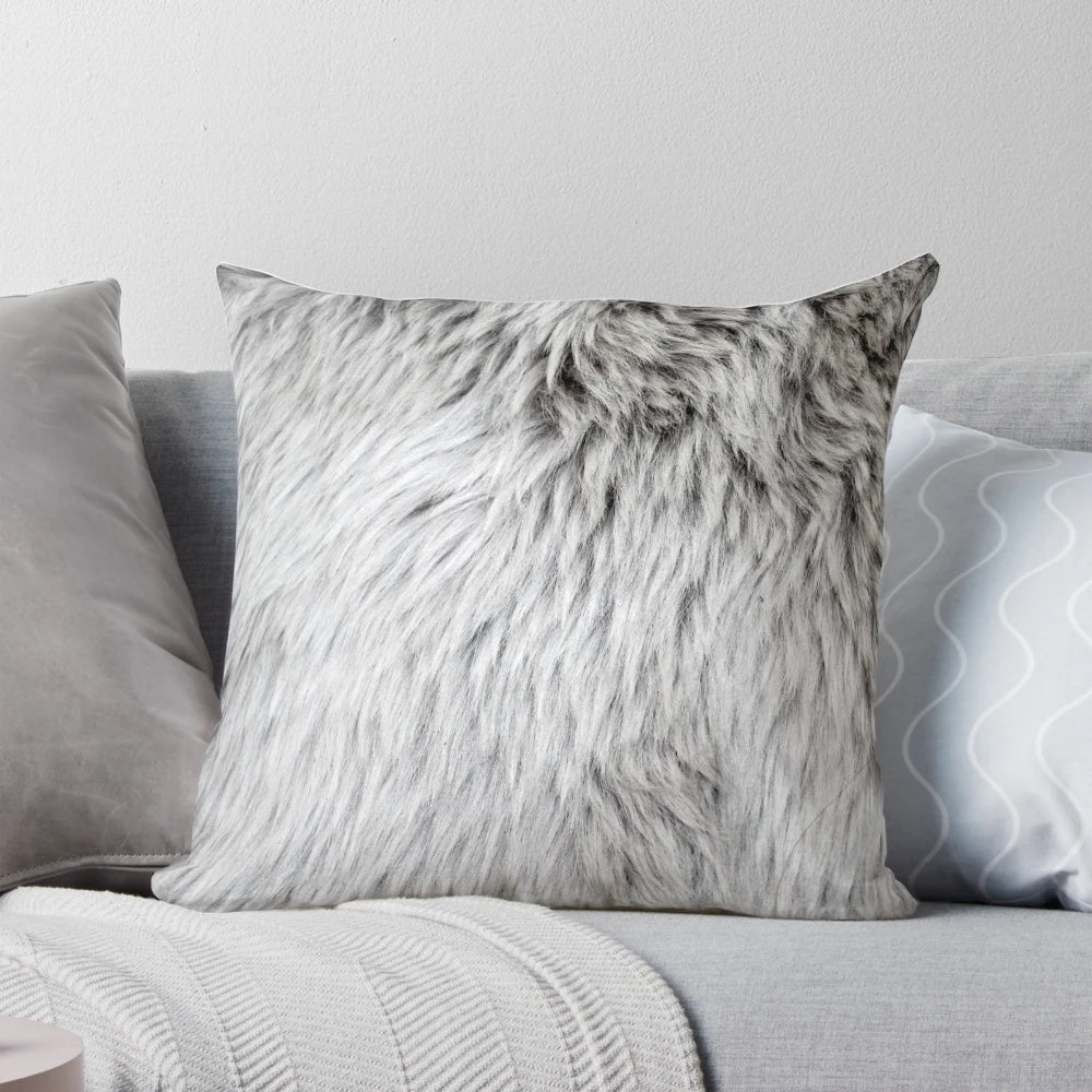 Close-up of a soft, fluffy grey faux fur pillow