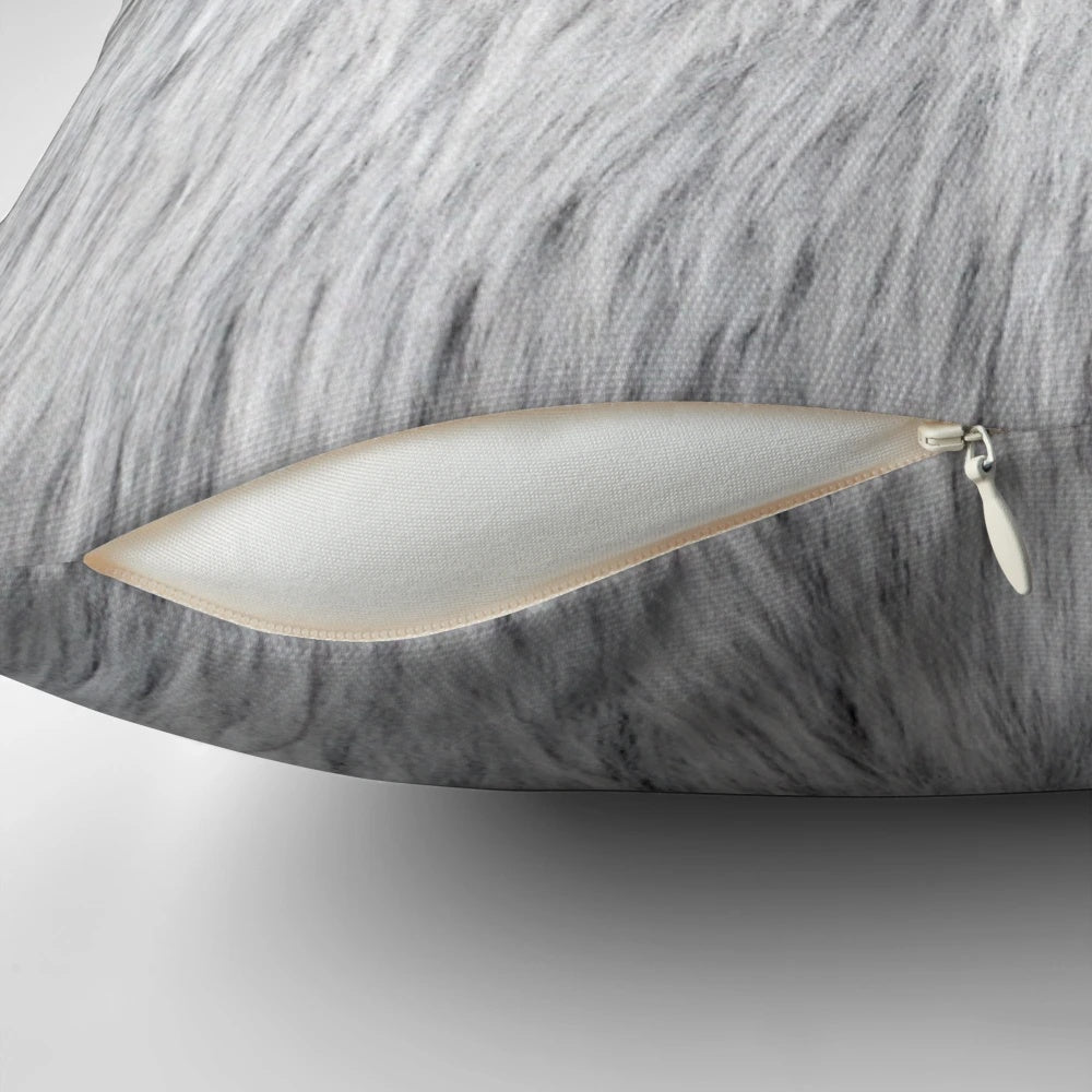 Close-up of a soft, fluffy grey faux fur pillow