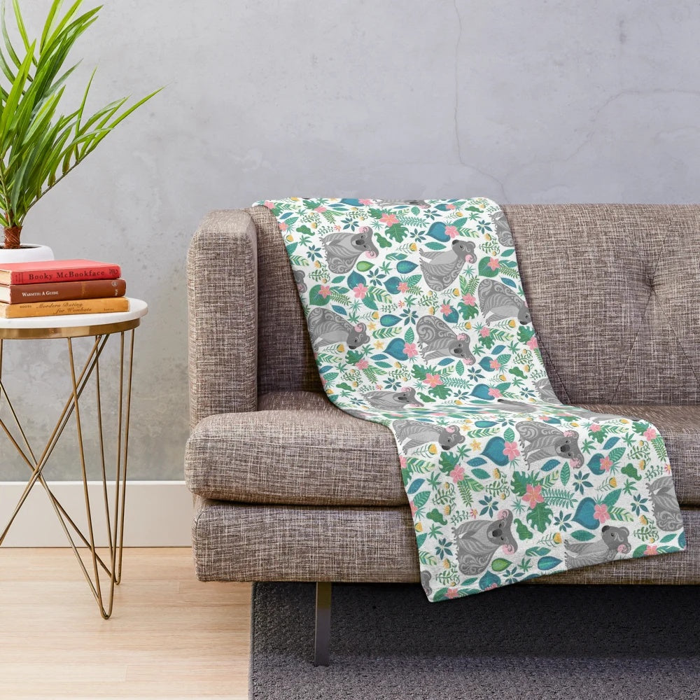 Grey koala pattern plush blanket with tropical flowers, leaves, and ornaments