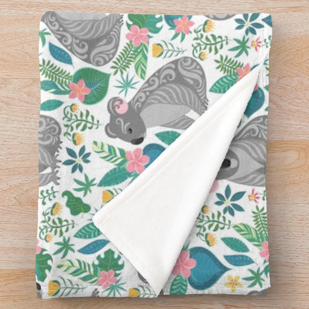 Grey koala pattern plush blanket with tropical flowers, leaves, and ornaments