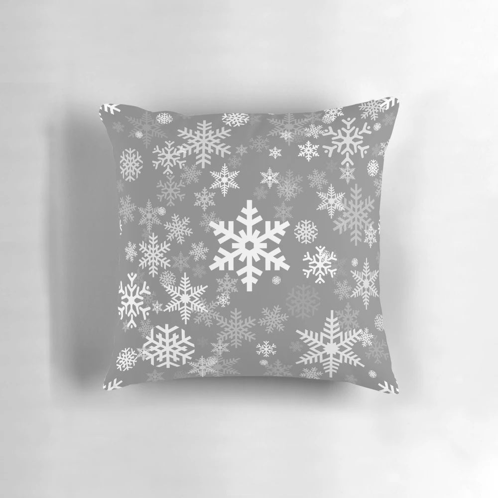 Grey pillow with a delicate snowflake pattern, perfect for winter and holiday home decor