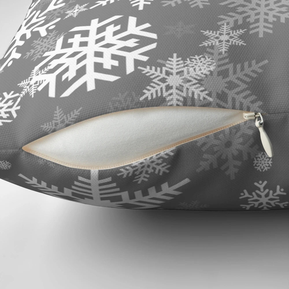 Grey pillow with a delicate snowflake pattern, perfect for winter and holiday home decor