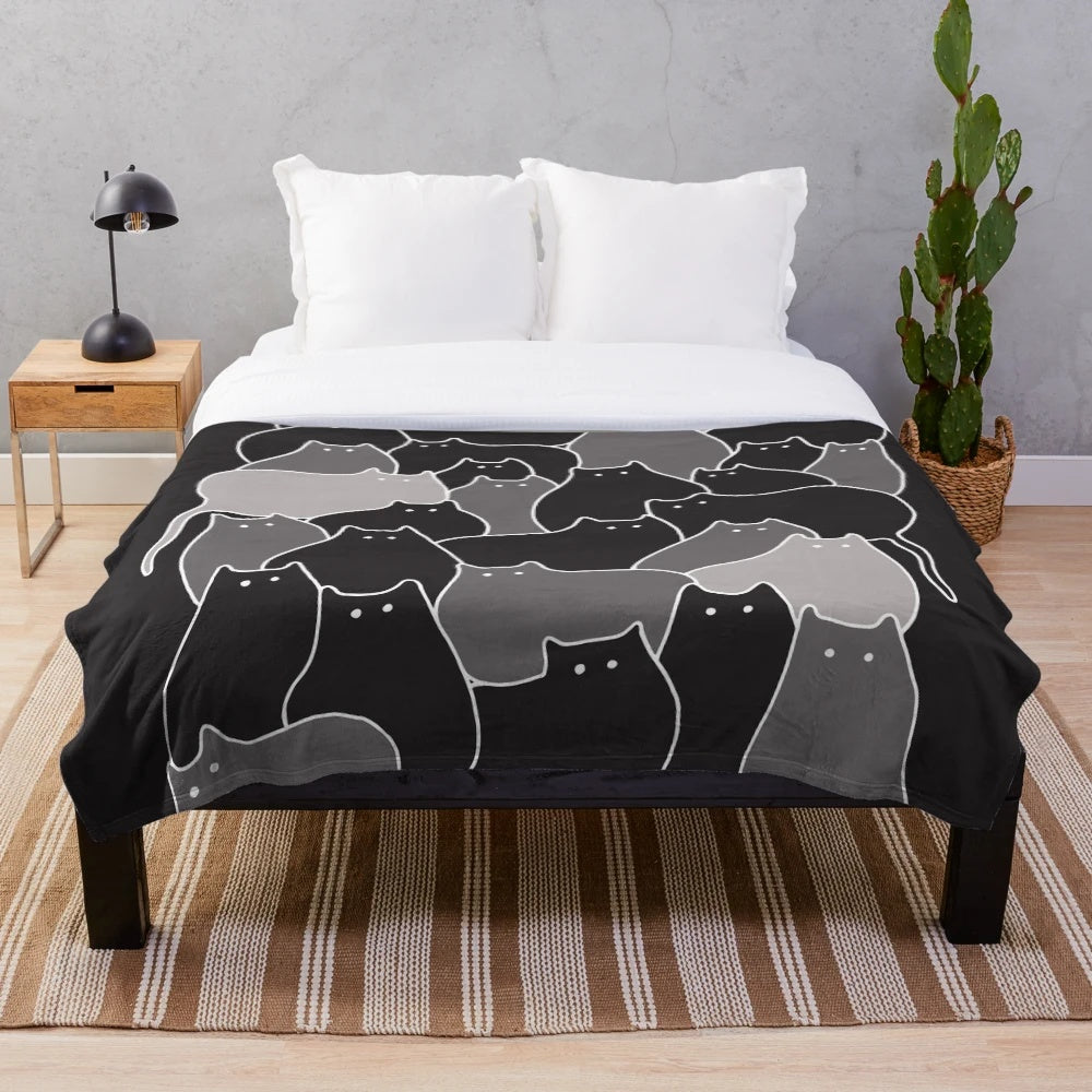 Grey plush blanket with a whimsical hand-drawn cats illustration in black and white line art