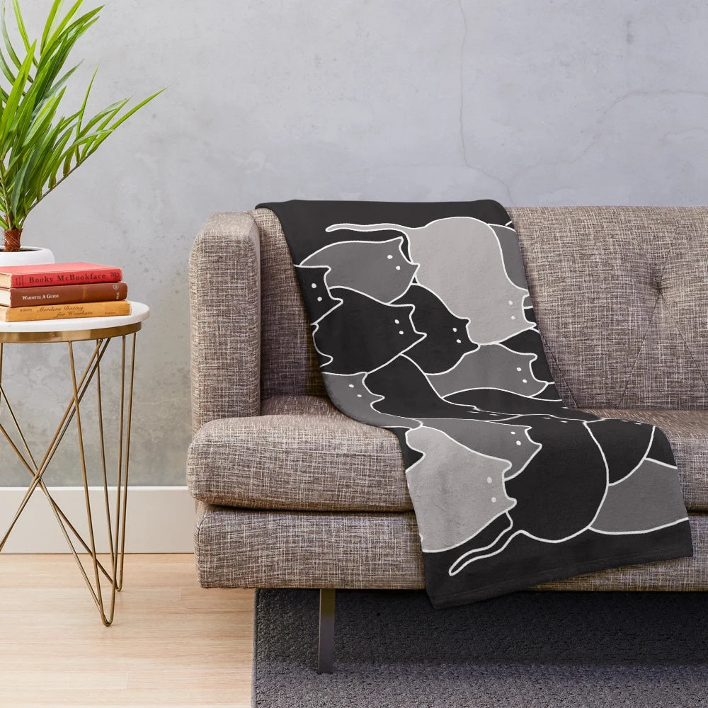 Grey plush blanket with a whimsical hand-drawn cats illustration in black and white line art