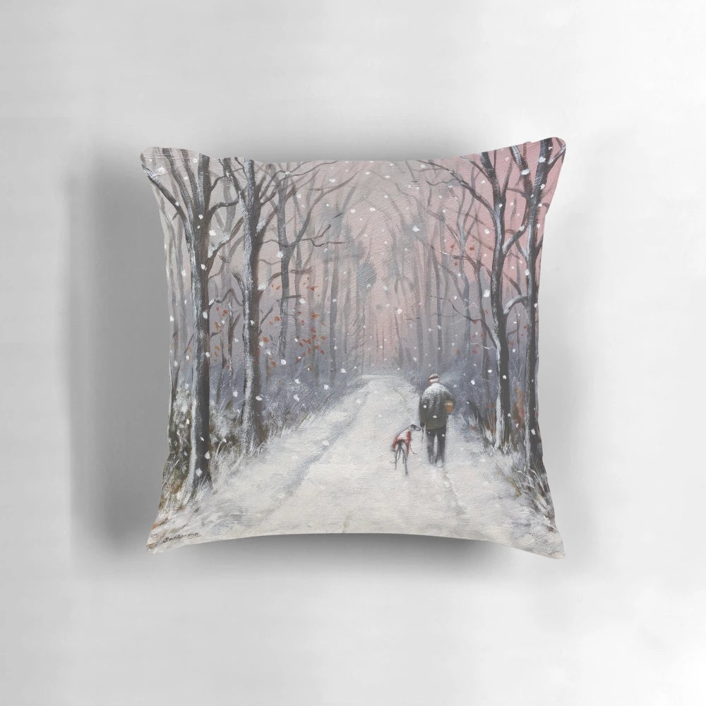 A cozy, winter-themed pillow featuring a charming greyhound or whippet dog in a snowy, holiday landscape.