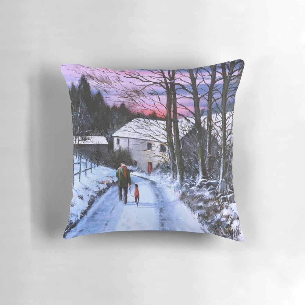 A cozy Pillow featuring a greyhound in a winter landscape with snow and trees.