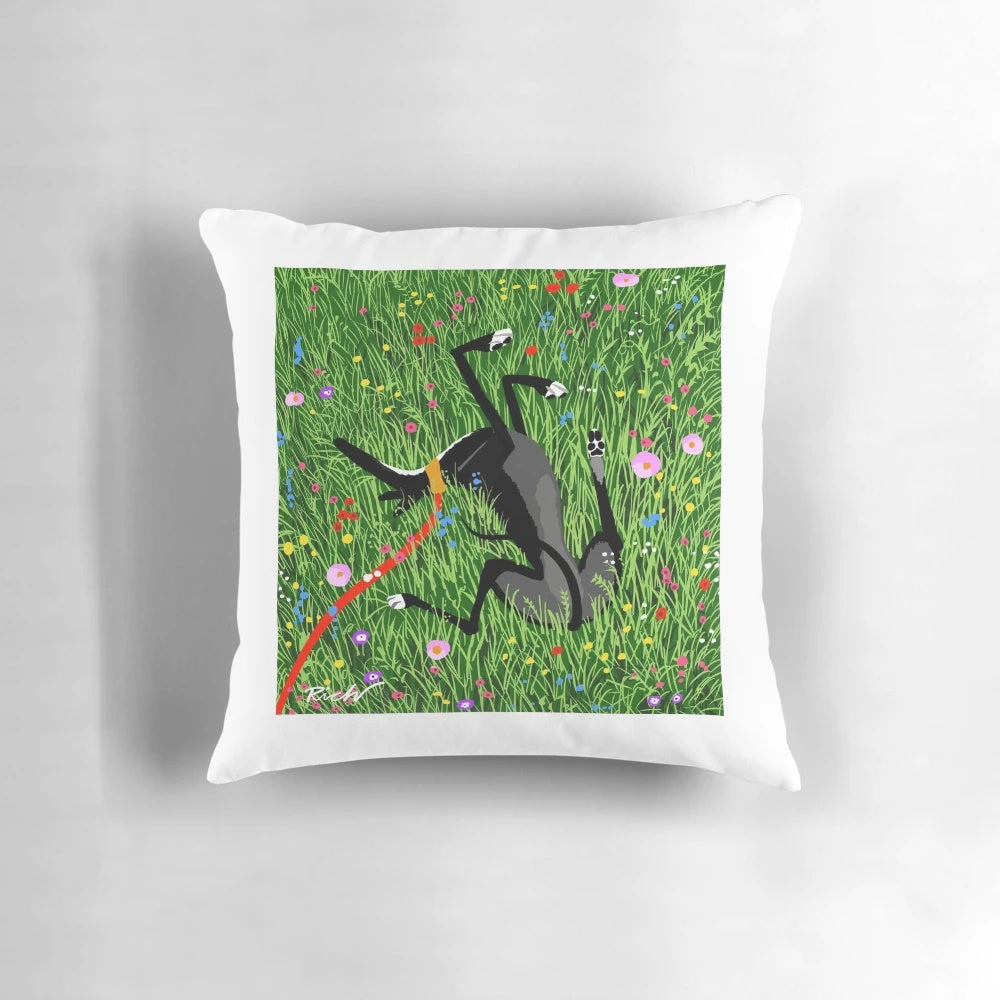 Decorative pillow featuring a greyhound dog resting in a field of colorful wildflowers