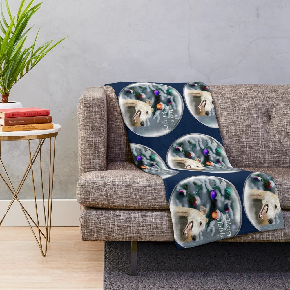 Greyhound dog lying on a plush holiday-themed blanket