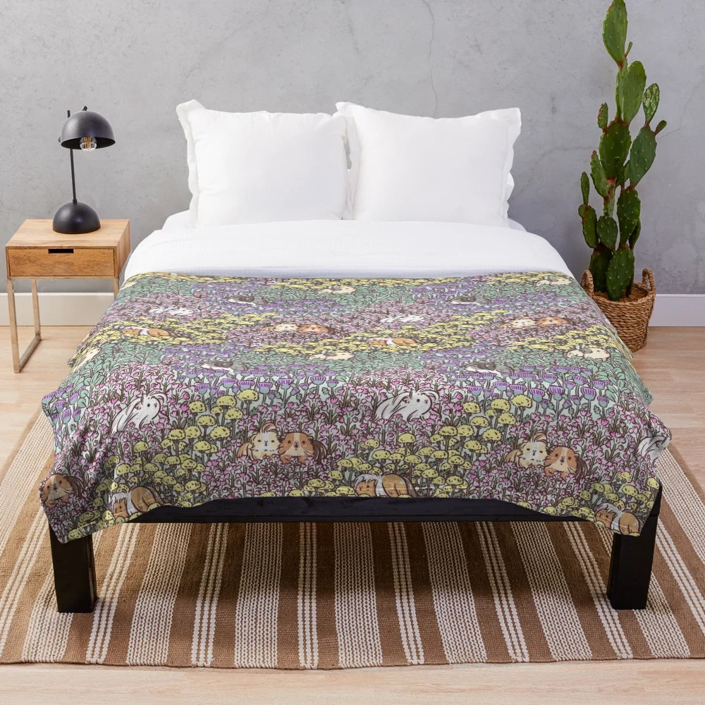 Soft and fluffy guinea pig plush blanket with a vibrant floral garden pattern