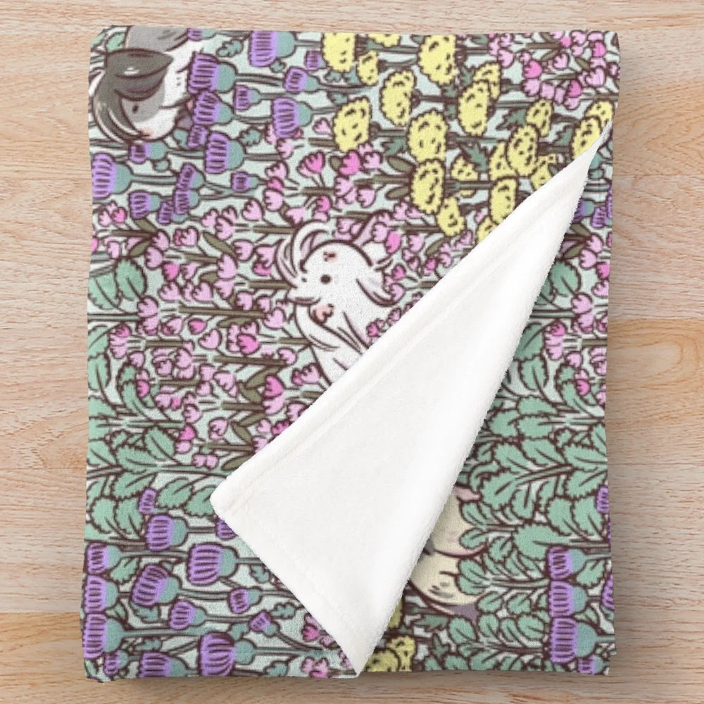 Soft and fluffy guinea pig plush blanket with a vibrant floral garden pattern