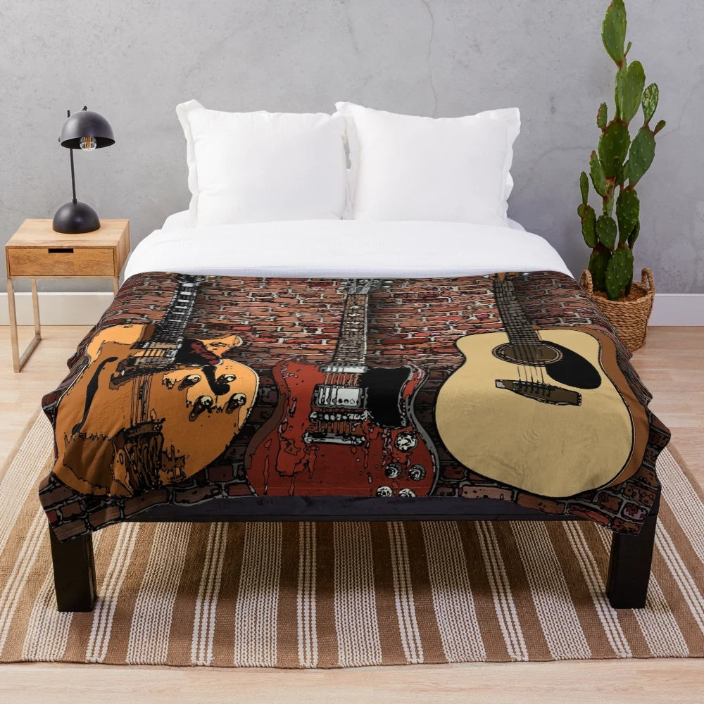 Plush blanket featuring three guitars in a musical design