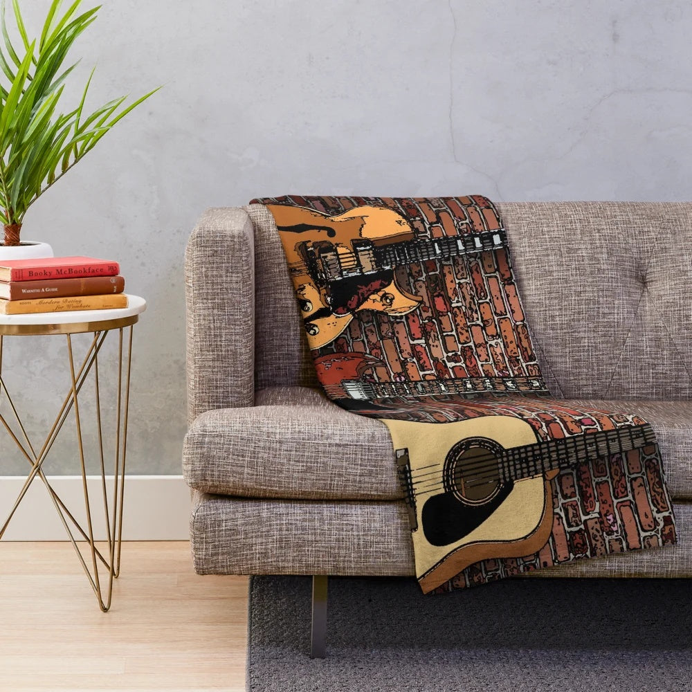 Plush blanket featuring three guitars in a musical design