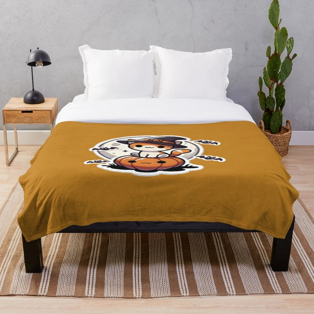 Cute Halloween cat sitting on a pumpkin on a plush blanket