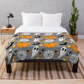 Cozy Halloween patterned plush blanket with pumpkin, spider web, candy corn, and other spooky designs