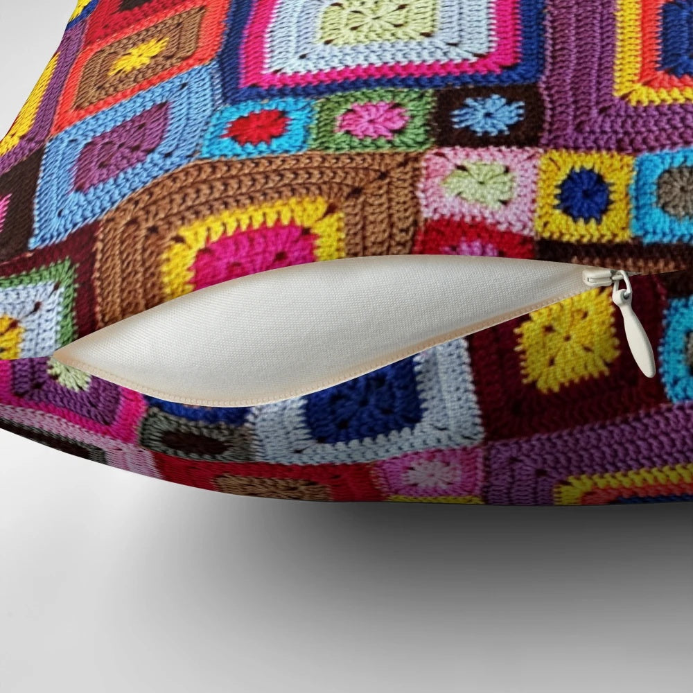 A cozy, handmade crochet pillow in a vibrant vintage granny chic style.