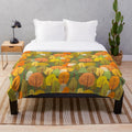 Plush blanket with a design of cute ghosts and trees in an autumnal forest