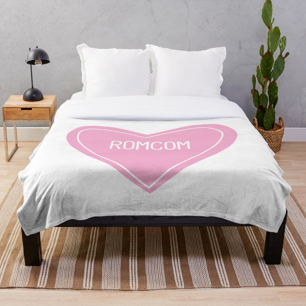 Soft, heart-shaped plush blanket perfect for romantic comedy lovers