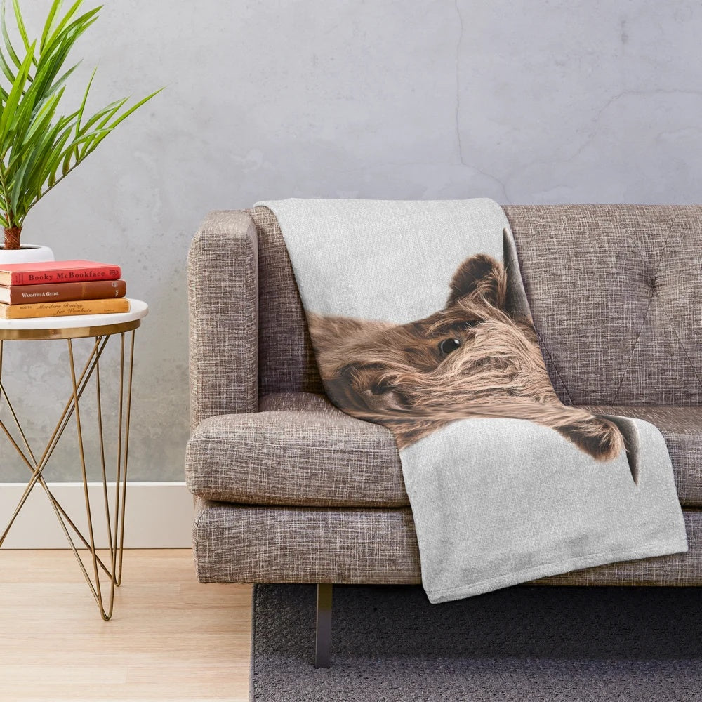 Soft and cuddly plush blanket featuring a cute highland calf design