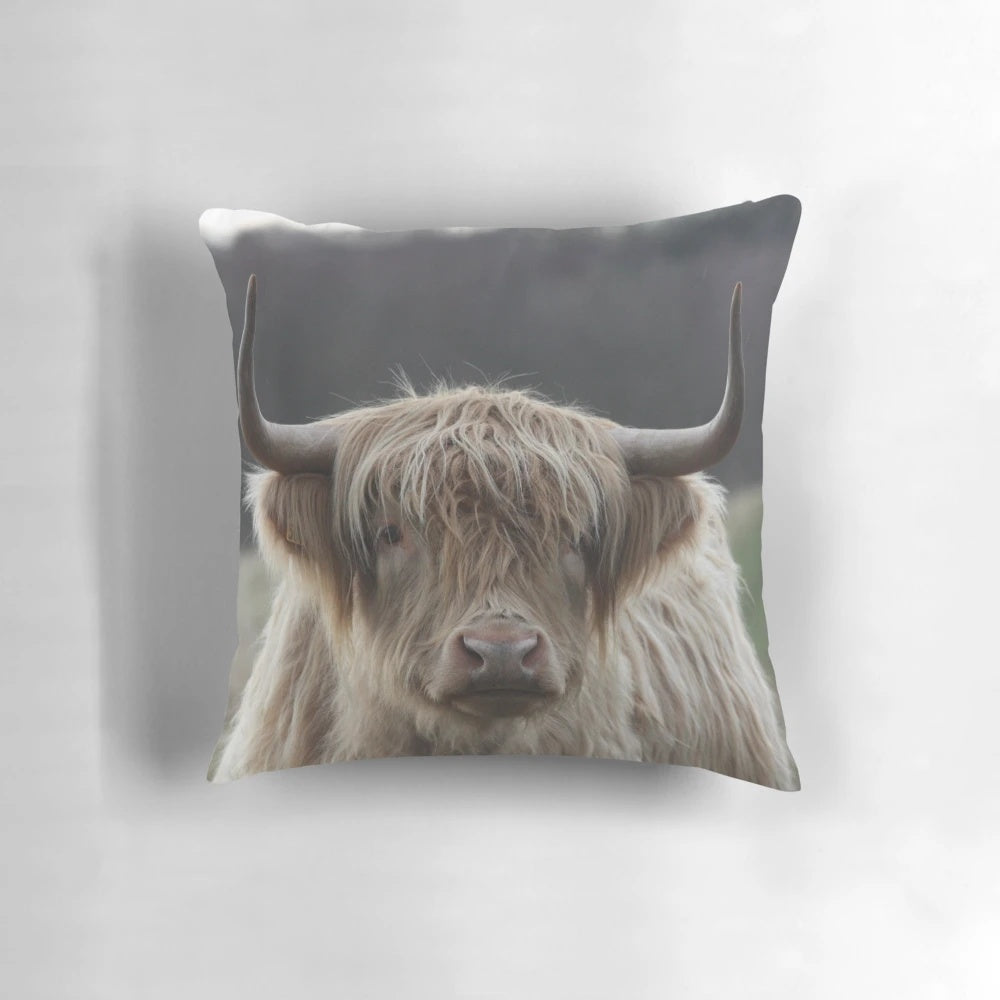 A plush, high-quality pillow featuring a realistic highland cattle design, perfect for adding a rustic, farmhouse touch to your home decor.