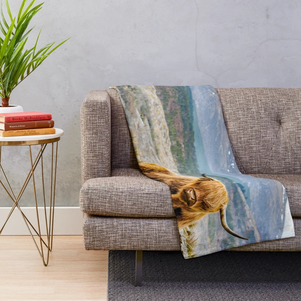 Soft and cuddly plush blanket featuring a cute and hairy highland cow