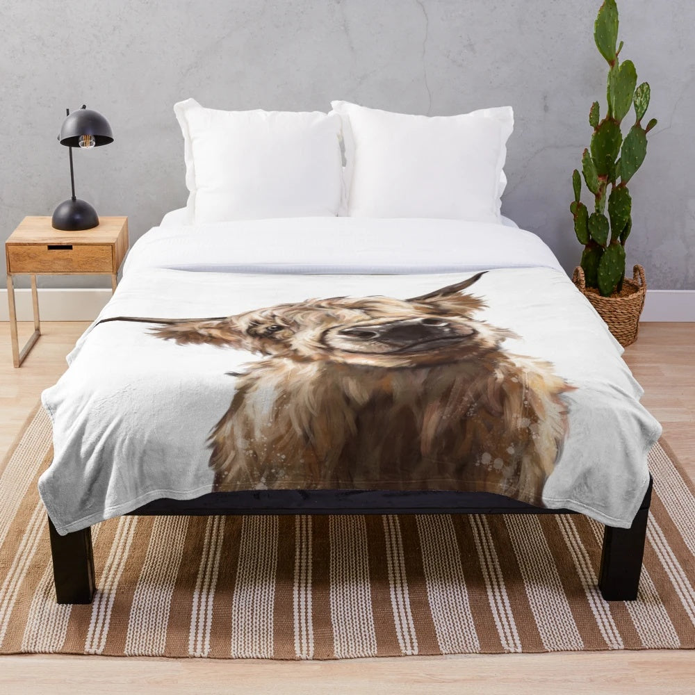 Highland cow plush blanket with soft, furry texture