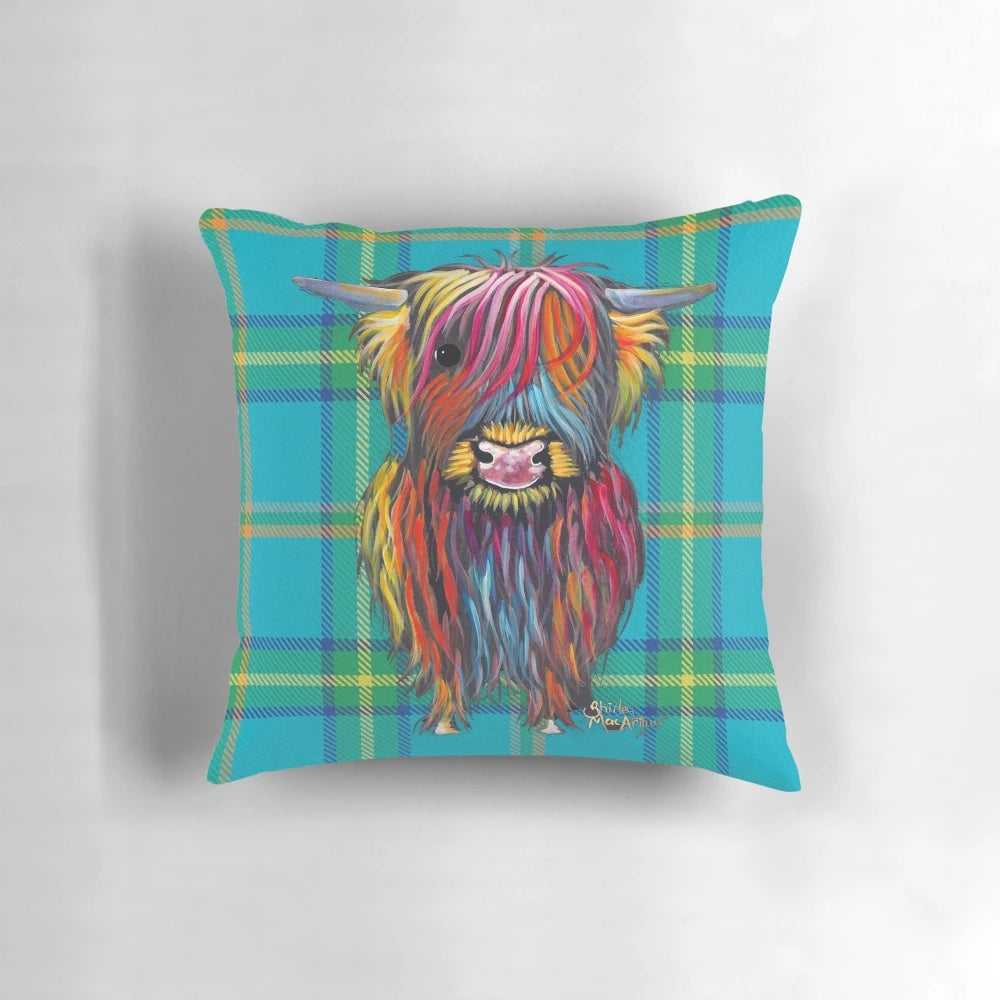 Colorful tartan pattern pillow featuring a friendly highland cow design