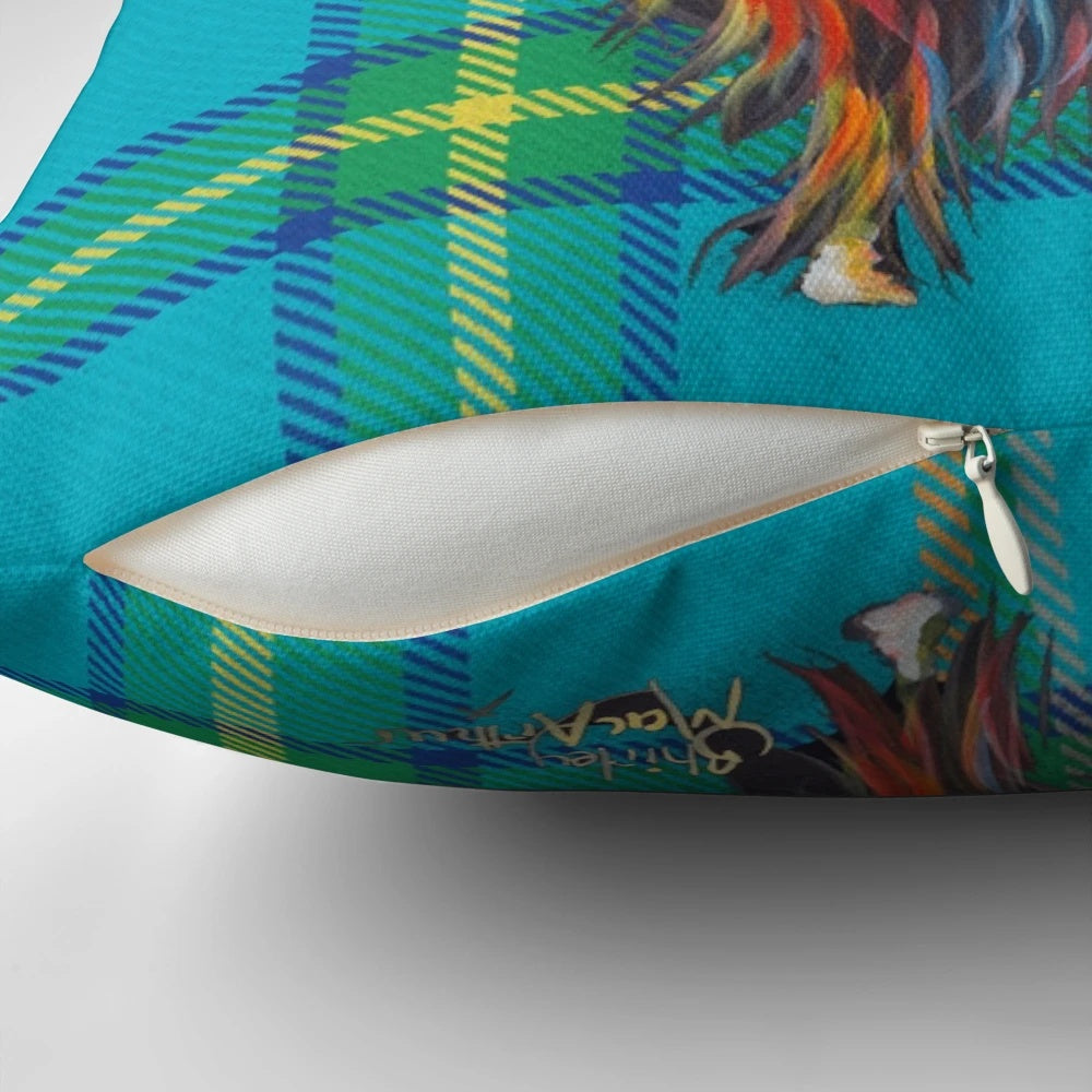 Colorful tartan pattern pillow featuring a friendly highland cow design