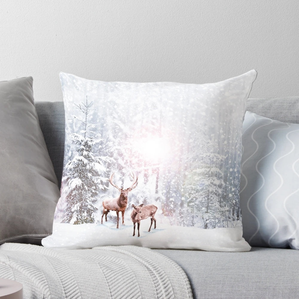 A cozy winter wonderland throw pillow with a deer stag design, surrounded by snowy trees.