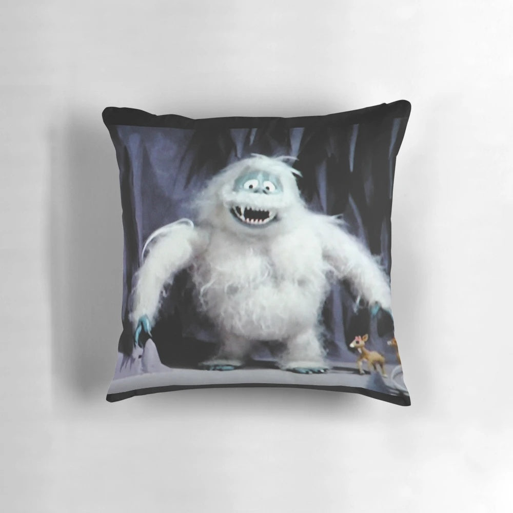 A plush decorative pillow featuring Rudolph, Bumble, and other beloved Christmas characters