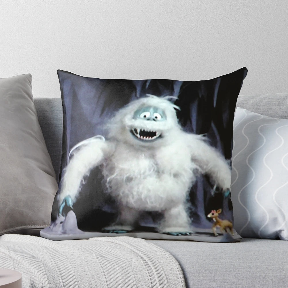 A plush decorative pillow featuring Rudolph, Bumble, and other beloved Christmas characters